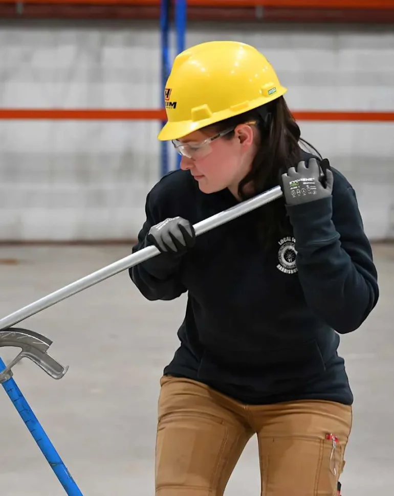 worker bending metal conduit